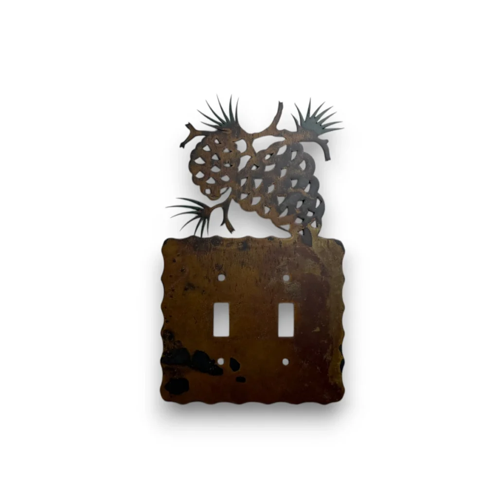 pine cones on a metal double switch cover