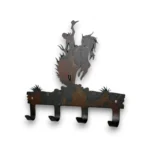 Hand-painted bronc rider metal key holder with four hooks, rustic weathered finish, and western rodeo ranch decor style.