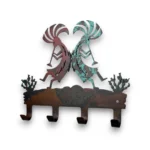 Hand-painted Kokopelli metal key holder with four hooks, turquoise and red accents, rustic weathered finish, and Southwestern decor style.