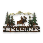 Hand-painted moose welcome metal wall art with pine trees, mountains, rustic weathered finish, and cabin lodge decor style.